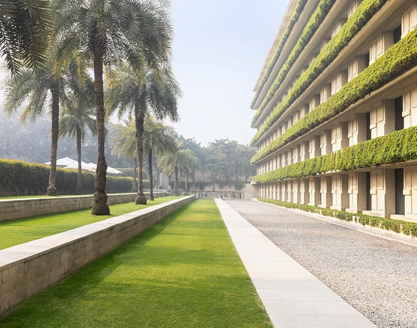 Green courtyard at The Oberoi, Gurgaon with palm trees.
