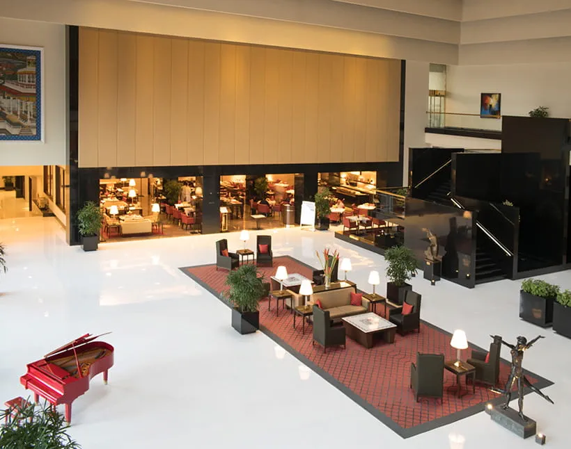 Luxurious lobby with red piano at The Oberoi, Mumbai.